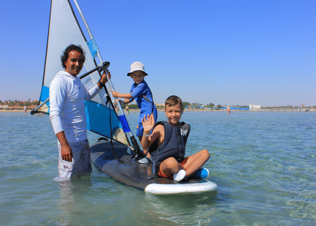 Kids learning windsurfing with instructor in Hurghada