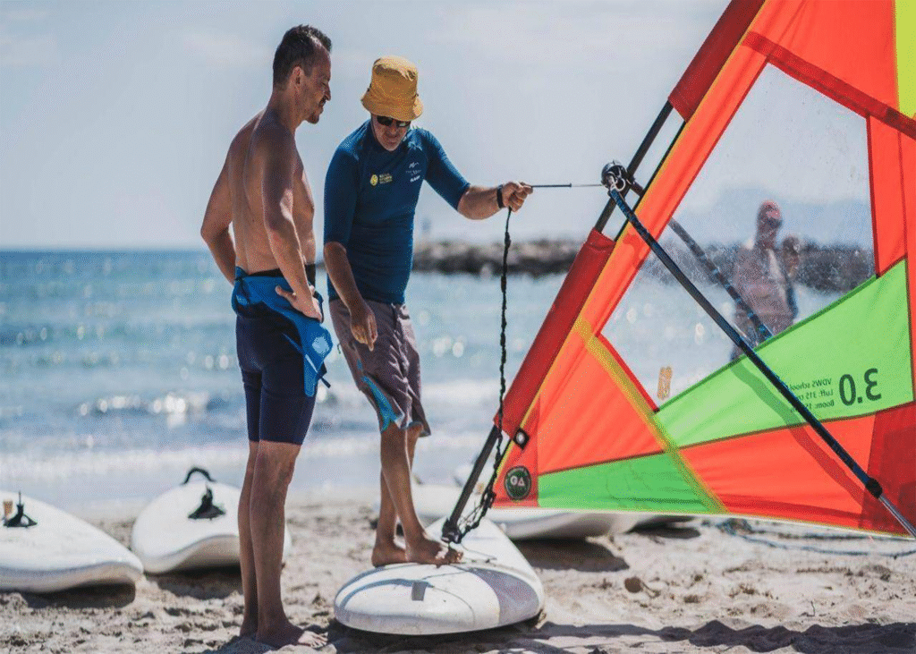 Instructor teaching how to hold a windsurf sail correctly