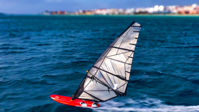 Windsurfer sailing across turquoise water at Soma Bay Hurghada Best Hurghada Windsurfing