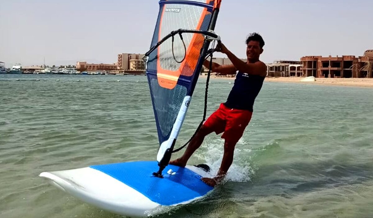 Windsurfer sailing on turquoise water in Hurghada during winter season