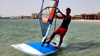 Windsurfer sailing on turquoise water in Hurghada during winter season
