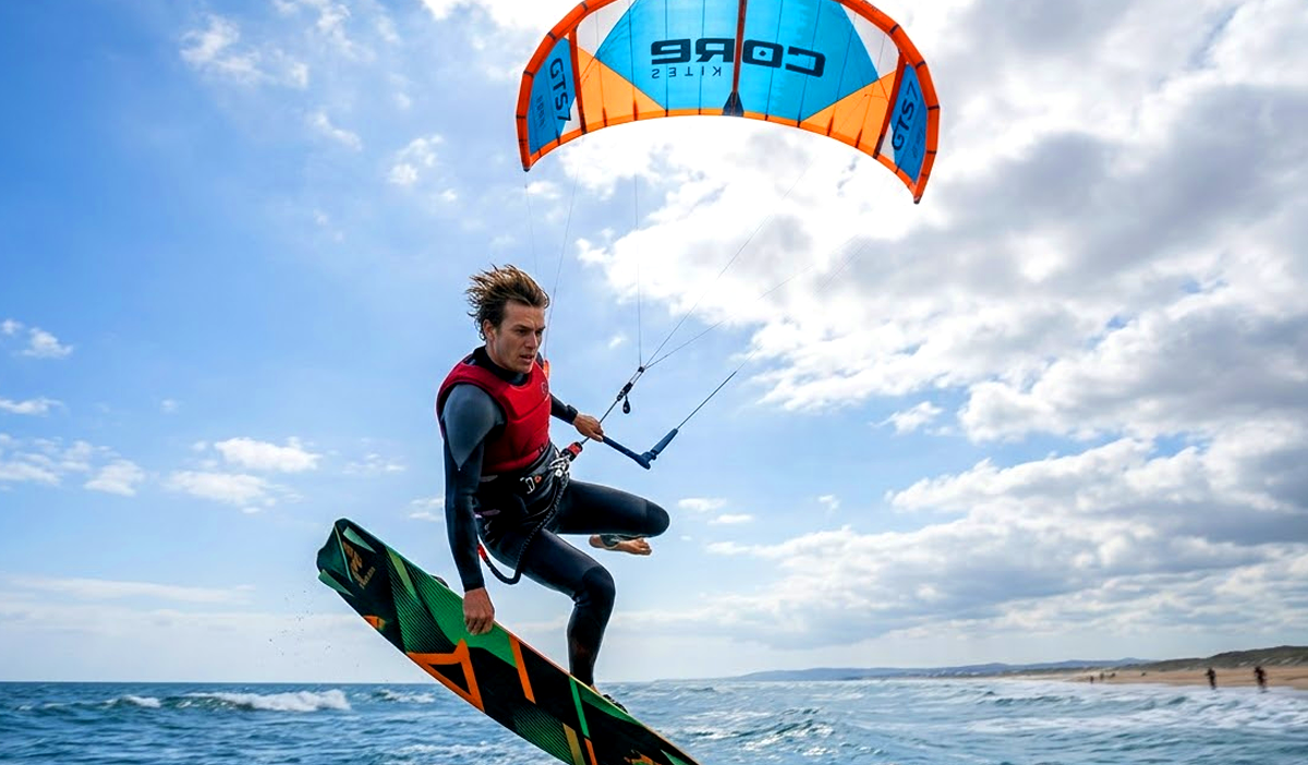 Kitesurfer boosting big air with kite overhead