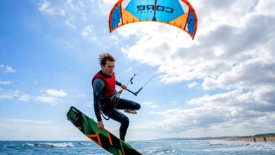 Kitesurfer boosting big air with kite overhead