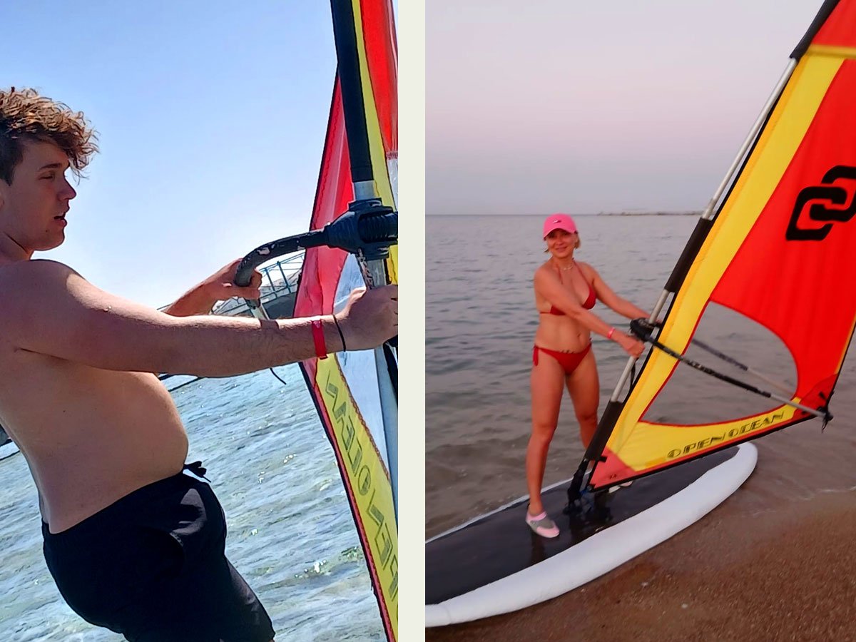 Windsurfer principiante de pie sobre un tablero de gran volumen en aguas poco profundas de Hurghada