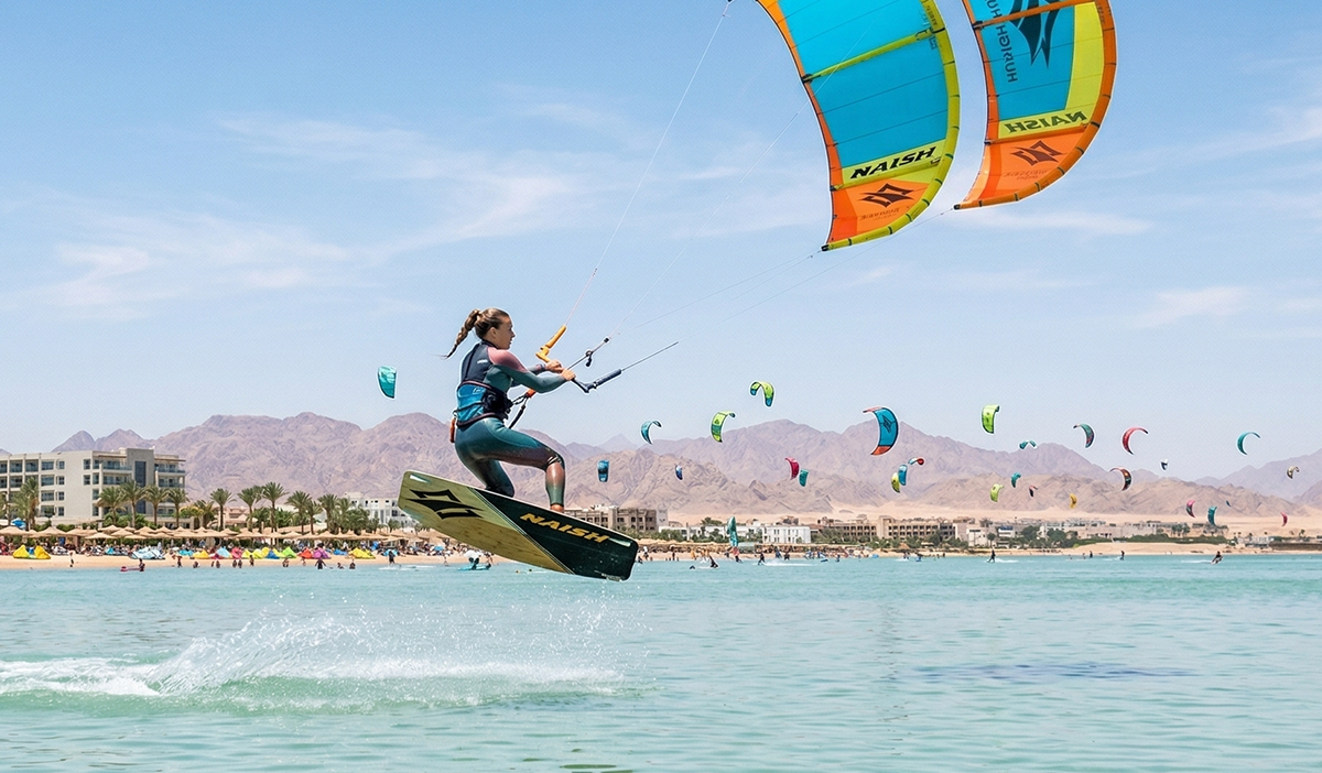 Kitesurfer jumping on flat water at Al Ahyaa Lagoon in Hurghada during peak summer season.