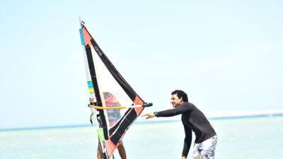Beginner windsurfer practising in shallow waters of Hurghada Masters surf school Lagoon, Egypt