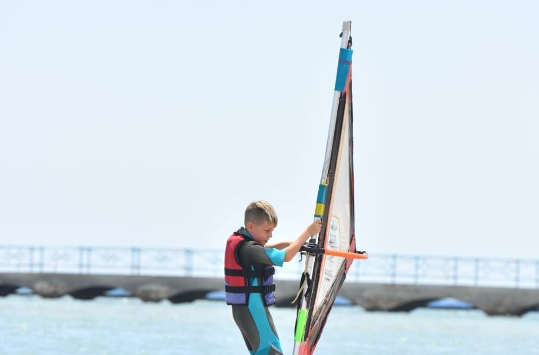 Beginner windsurfing lesson in waist-deep water at Al Ahyaa Lagoon, Hurghada