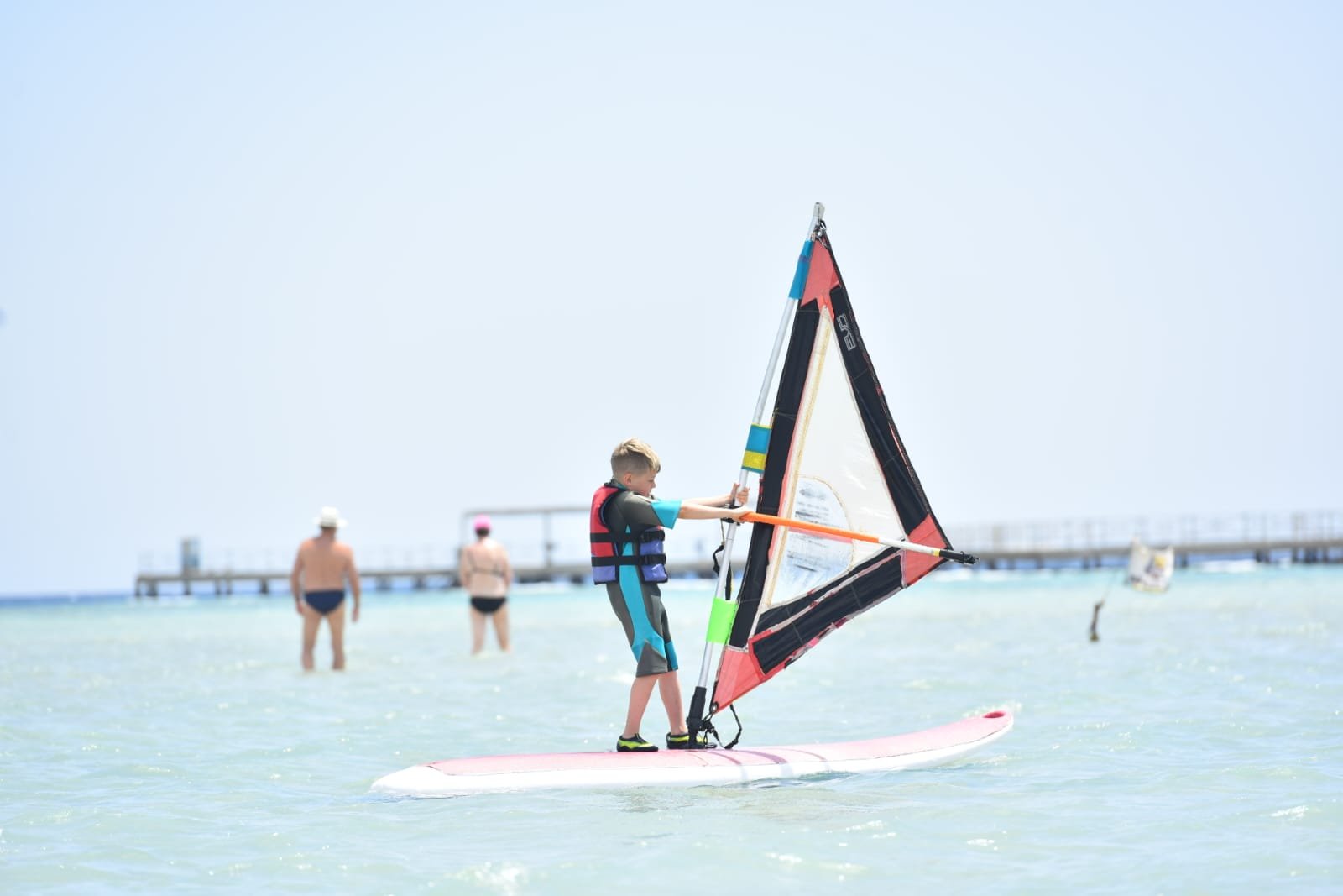 Windsurfer planing across shallow lagoon at Magawish, Hurghada Egypt