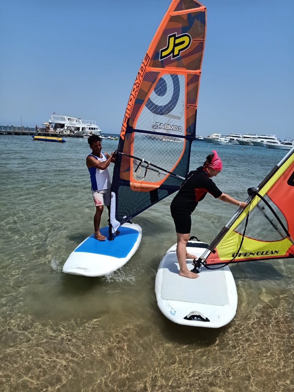 Windsurfer riding across turquoise water at Magawish Beach Hurghada July